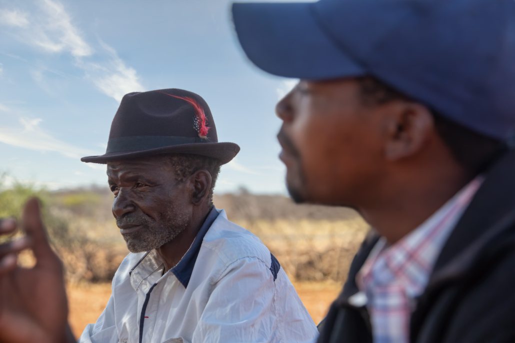 Elderly man and younger man discussing