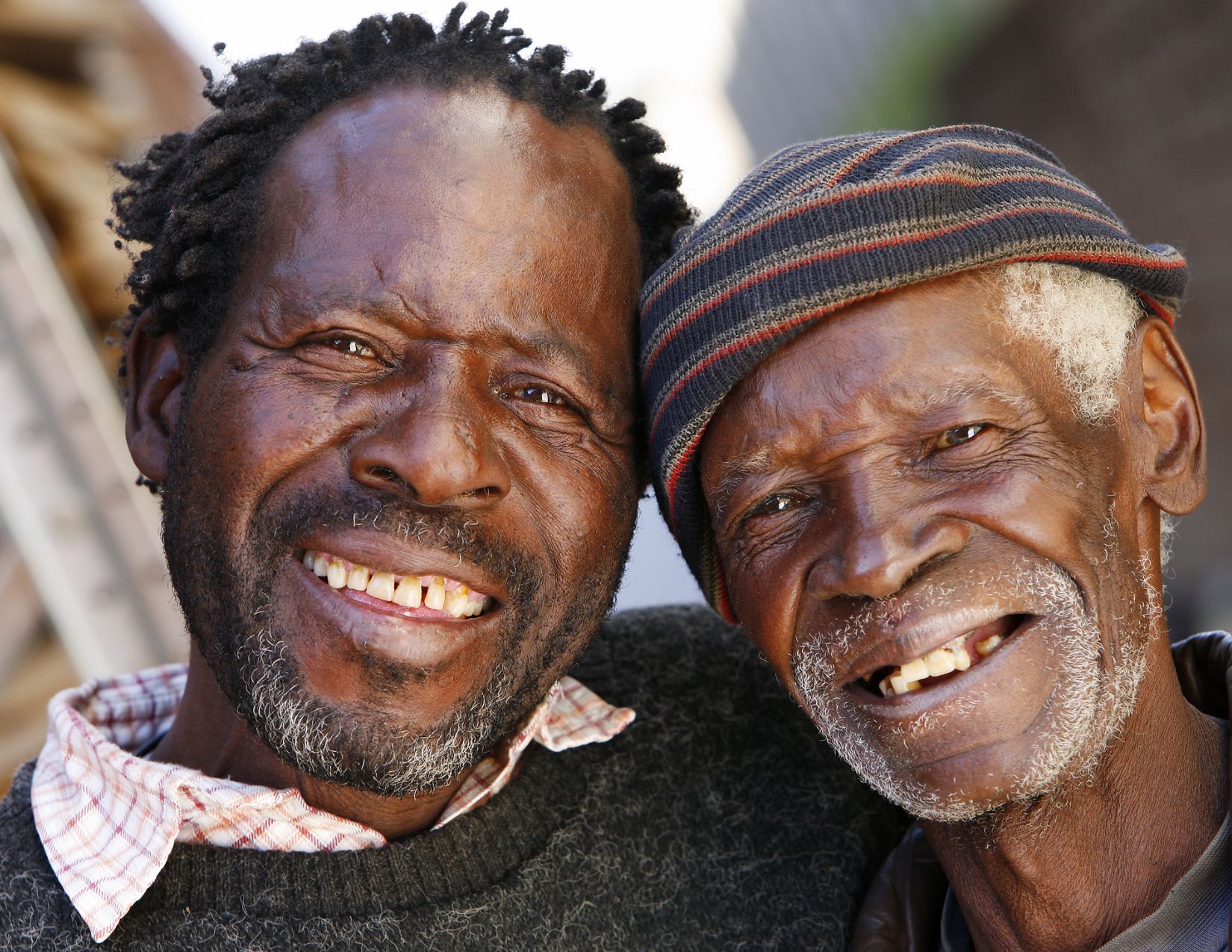 Two men smiling warmly side by side