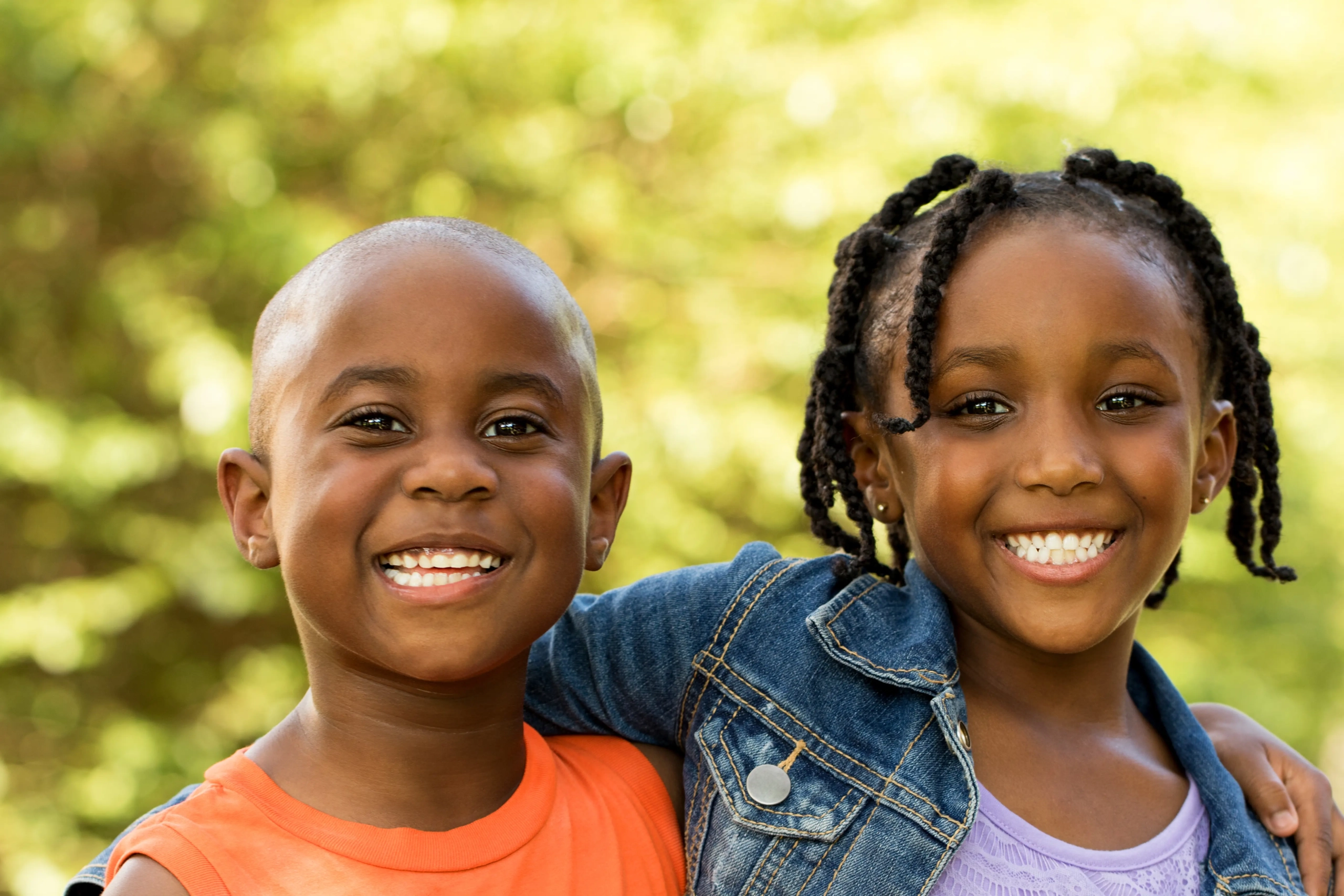 Two children smiling together outdoors
