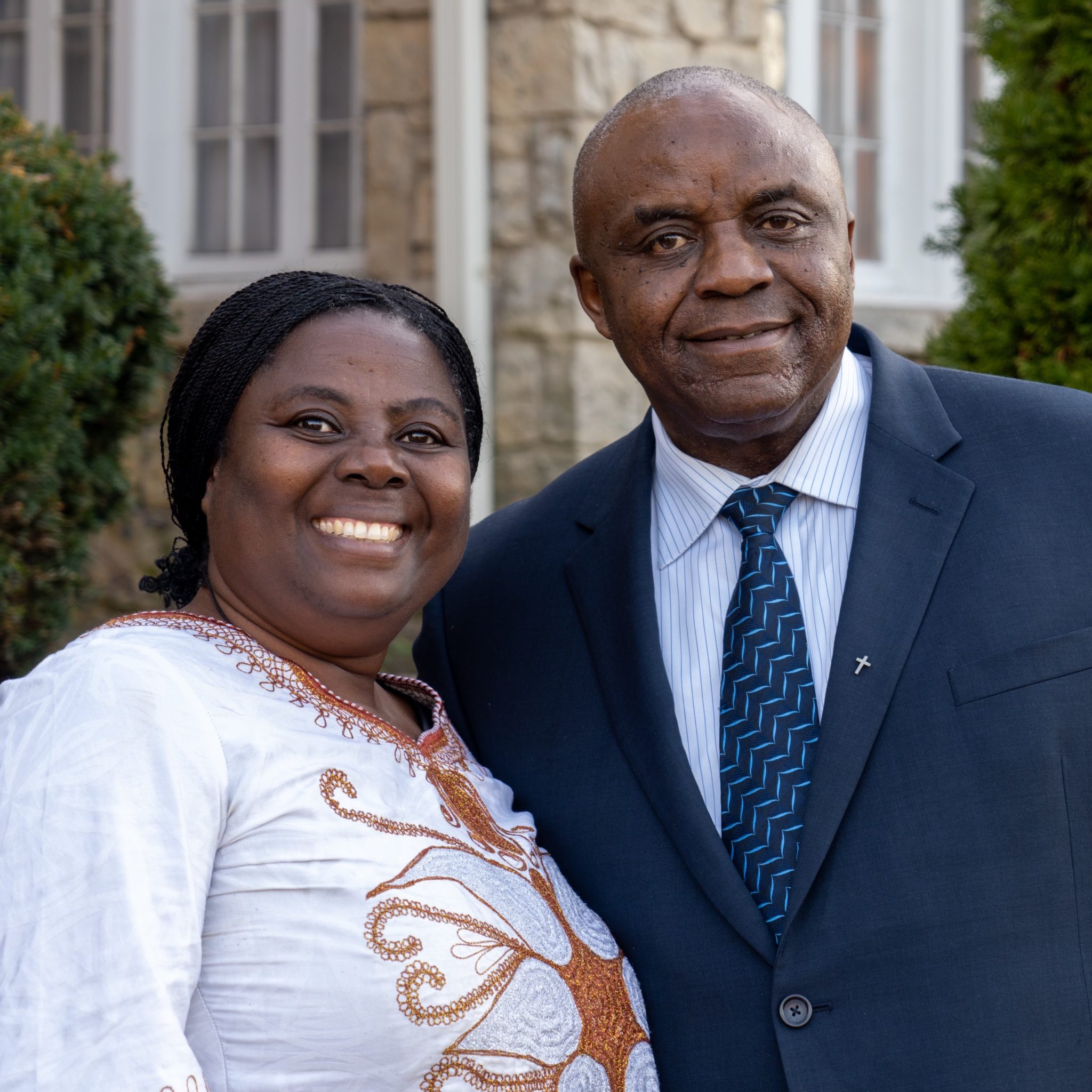 Dr. Pauline Mukeshimana and Rev. Jean de Dieu Nzeyimana, founders of Gate of Hope, standing together outdoors